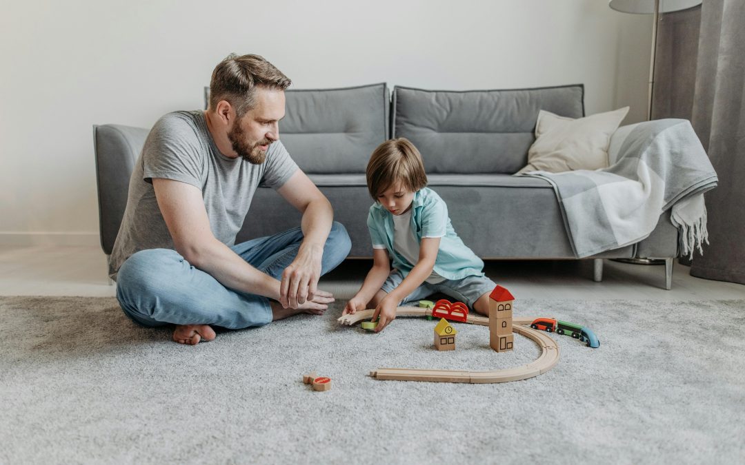 Father sitting on the floor playing with his son