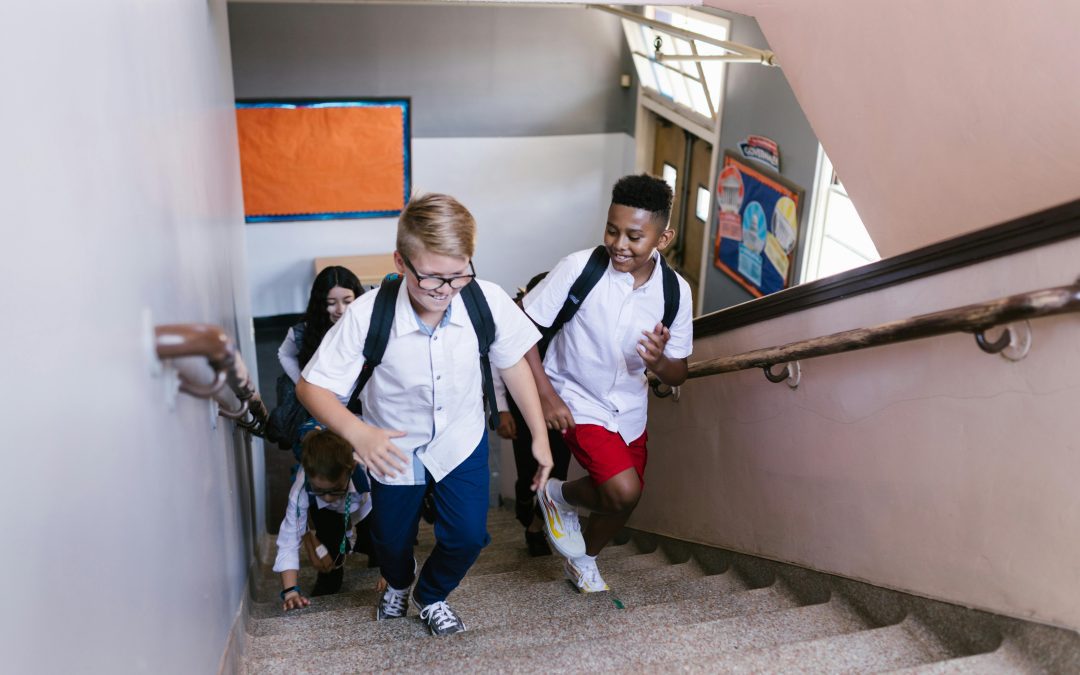 Children climb stairs of their new school