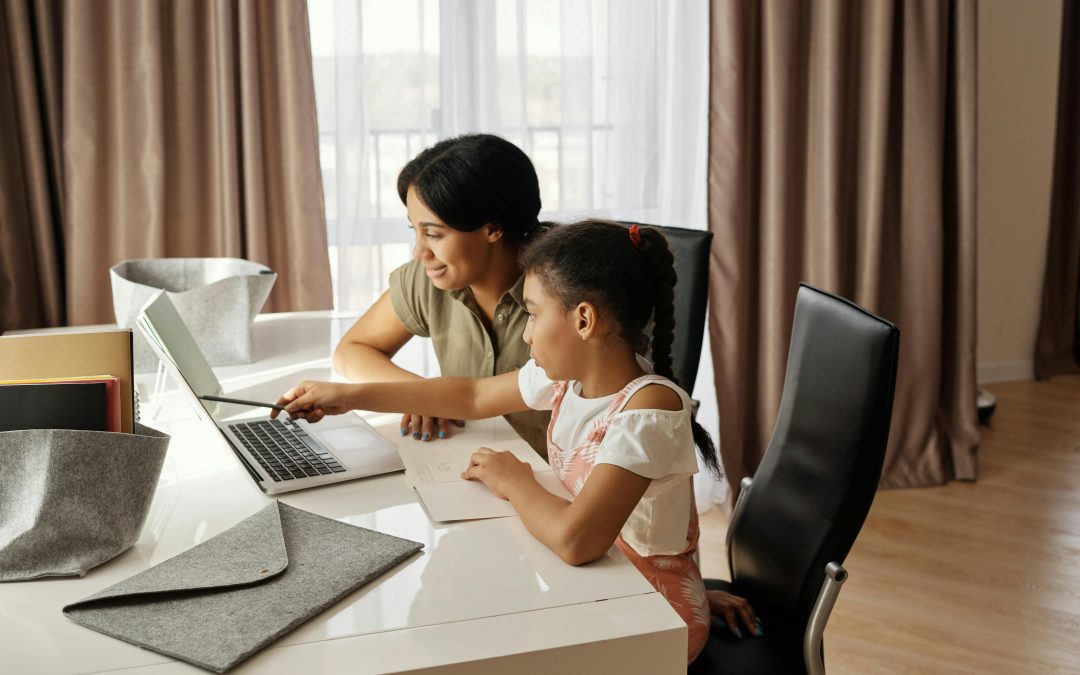 A person and a child using a computer