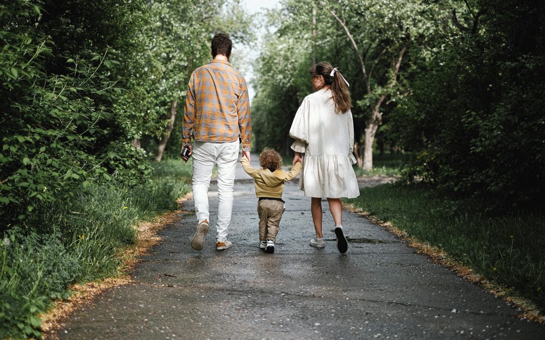 A couple and their child walking in the park