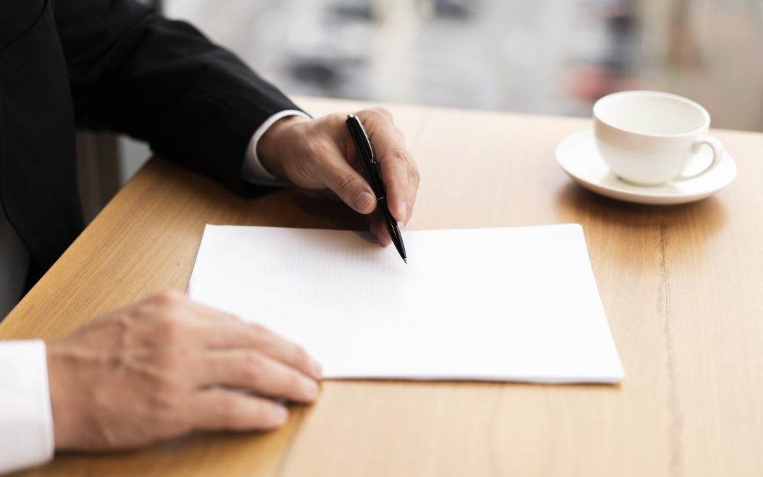 Man writing on paper and seems to be considering financial arrangements upon divorcing former spouse