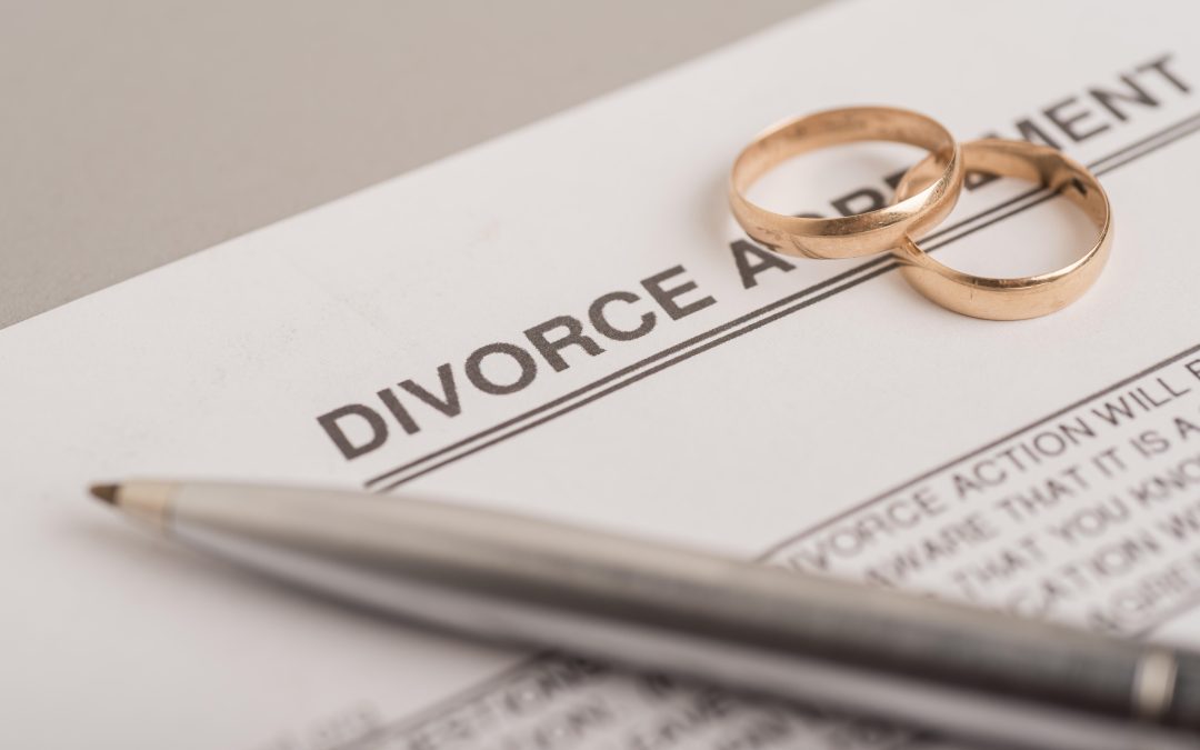 Couple place wedding rings on Divorce settlement document and discuss whether spousal maintenance will form part of their financial settlement